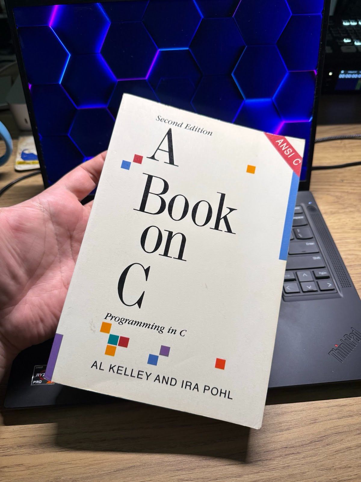 A book cover with the title "A Book on ANSI C." Below the title, it mentions "Programming in C" and displays the author's names, "Al Kelley and Ira Pohl." "Second Edition" is visible at the top, and the typography is clear and bold.